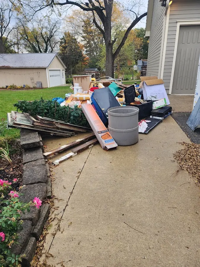 Dumpster being loaded with debris for 12 Yard Dumpster Rental in Roselle